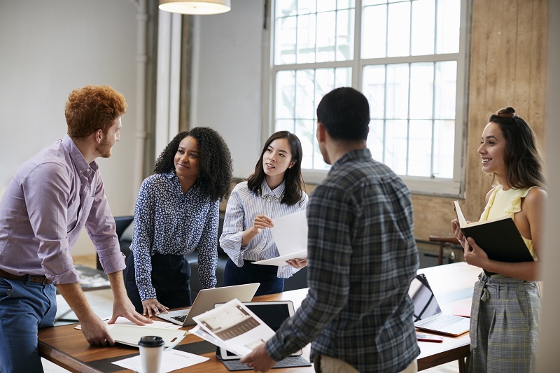 Young workers discussing brand reputation.