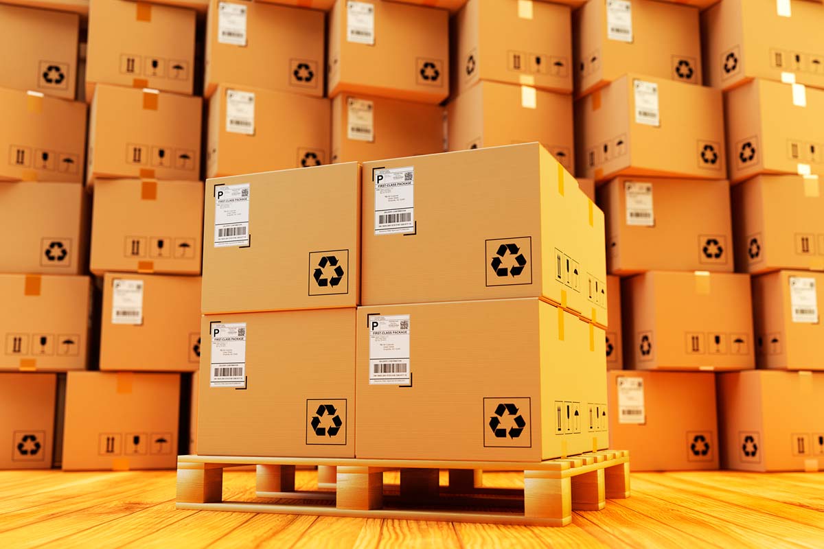 Numerous carton boxes stand stacked in a warehouse.