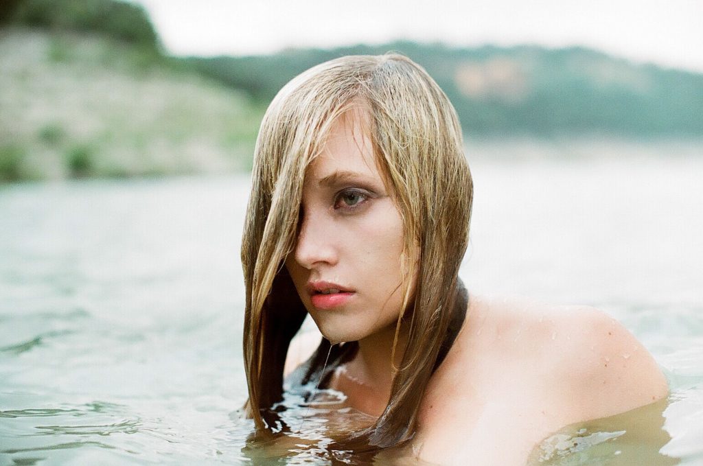 Photo of a swimmer emerging from the water.