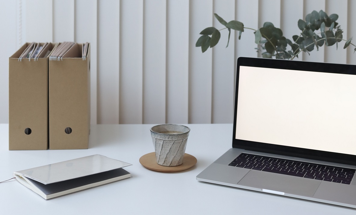 Folders next to a laptop.