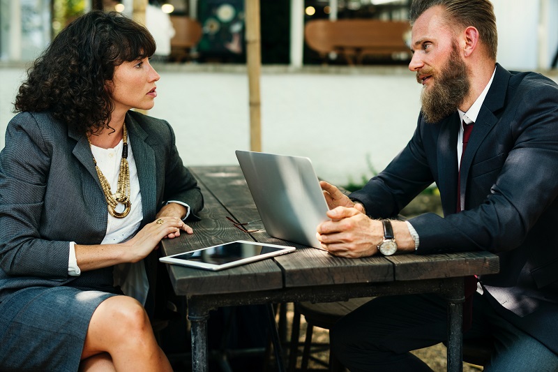 Two marketers collaborating on mobile devices.