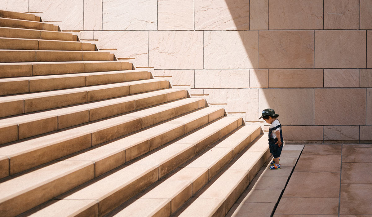 A person at the foot of a staircase.