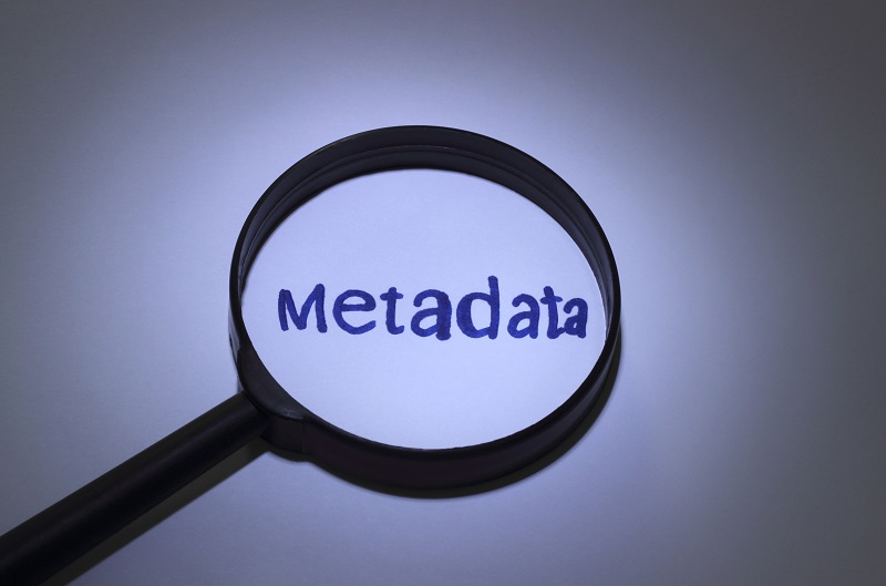 A magnifying glass amplifying the word 'metadata'.