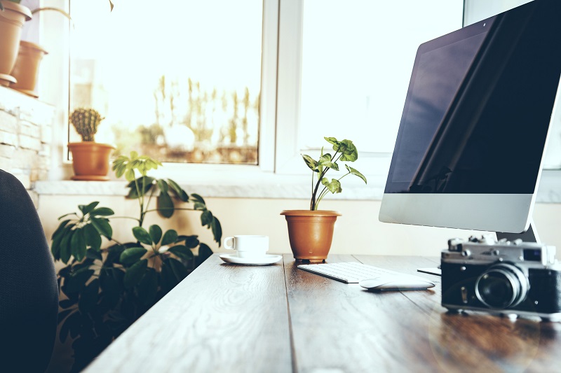 A camera on a computer desk.