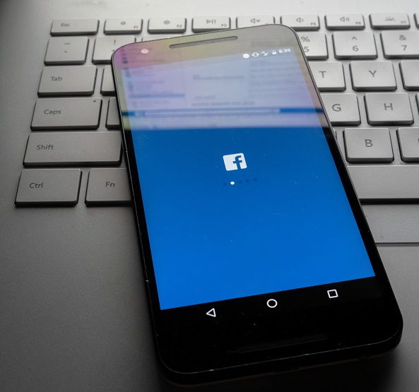 A picture of a phone with the Facebook icon.