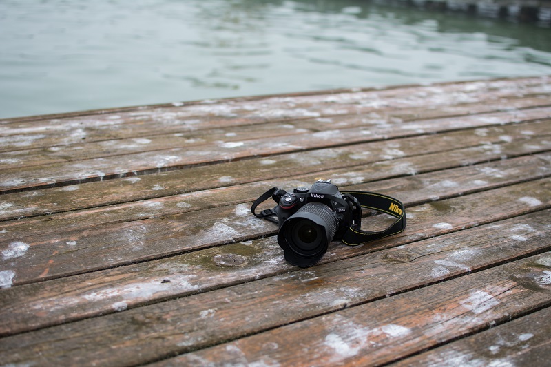 A Nikon camera on a dock.