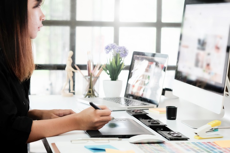 A woman working on graphic design projects.