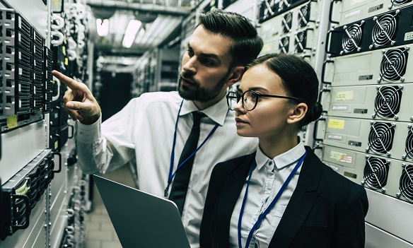 Man and woman working in a data center.