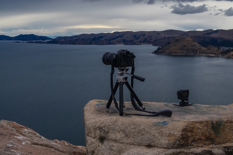 A picture of a camera photographing a lake.