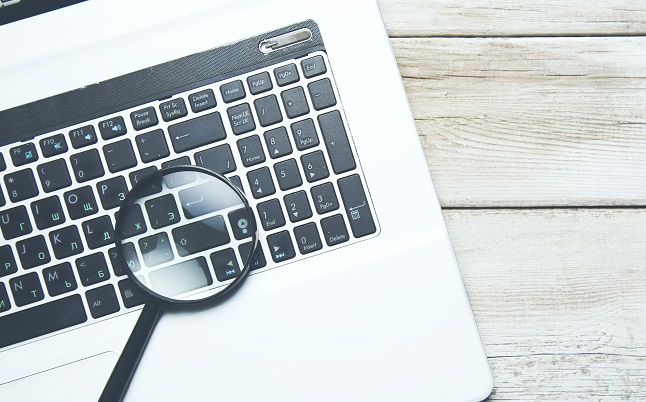 A magnifier on top of a laptop.