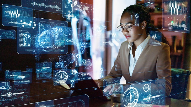 A young woman works on data on her computer.