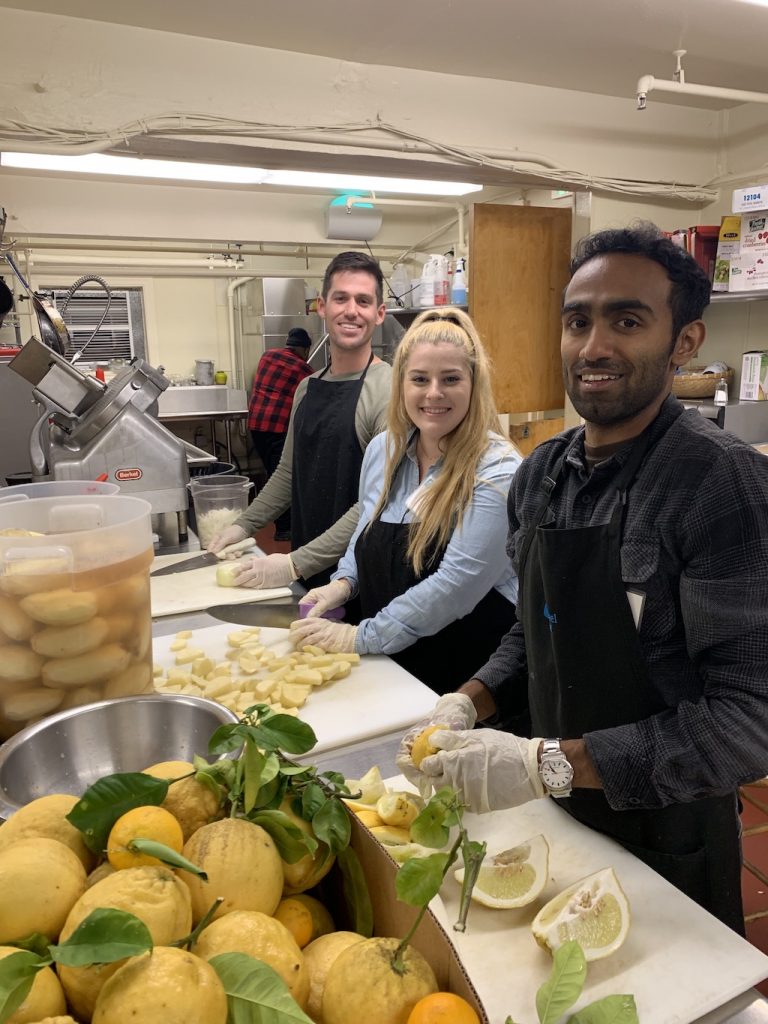 Canto Cares volunteers help prep a meal for families in need at Raphael House