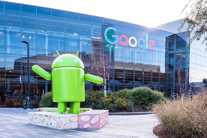 A picture of the Android mascot in front of a Google building.