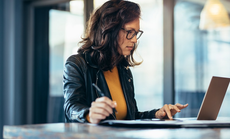 A woman using a laptop.