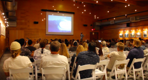 An audience listening to a presentation.