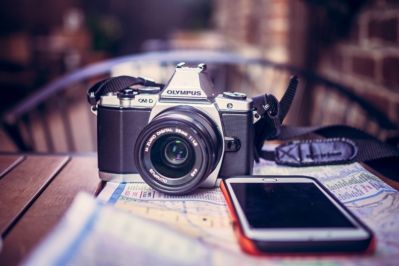 A camera on a map near a smartphone.