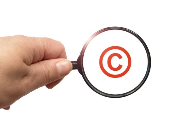 A magnifying glass with the copyright logo.