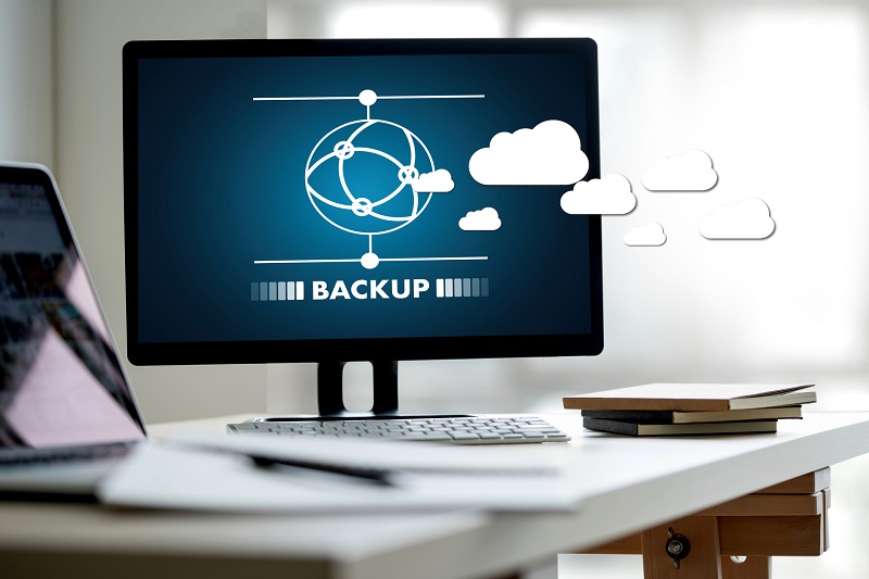 A picture of a laptop with a symbol and the word 'backup' on the screen.