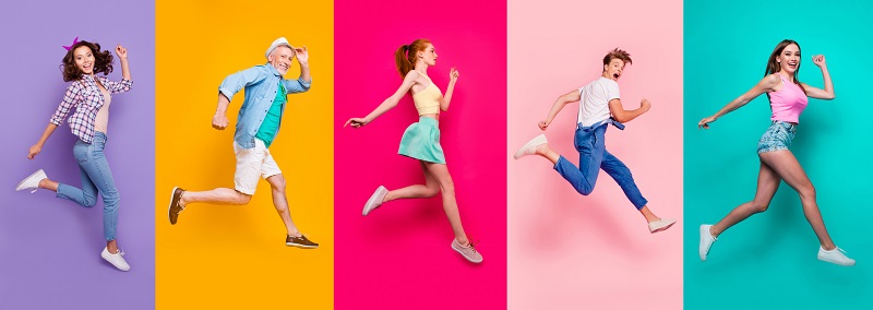 Happy people jumping on colored backgrounds.