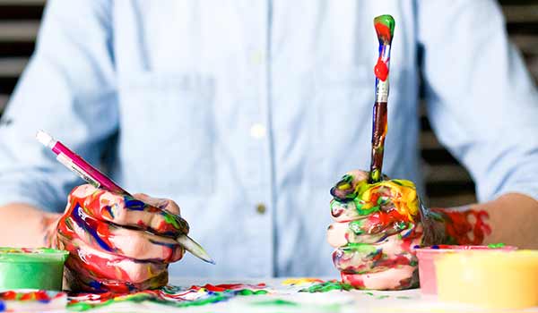 A person with paint on their hands.