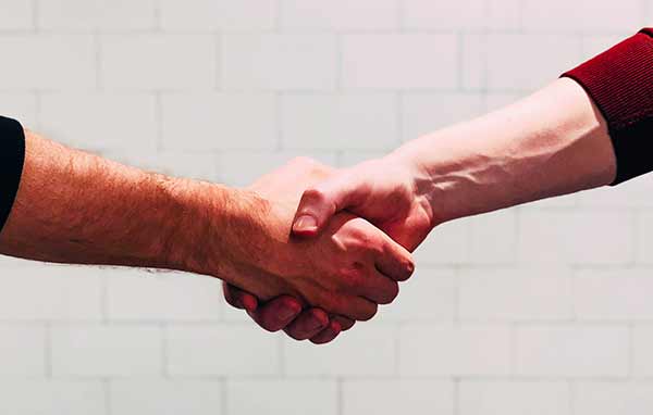 Two people shaking hands.