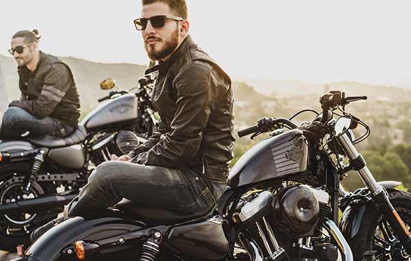 A man sitting on a motorcycle.