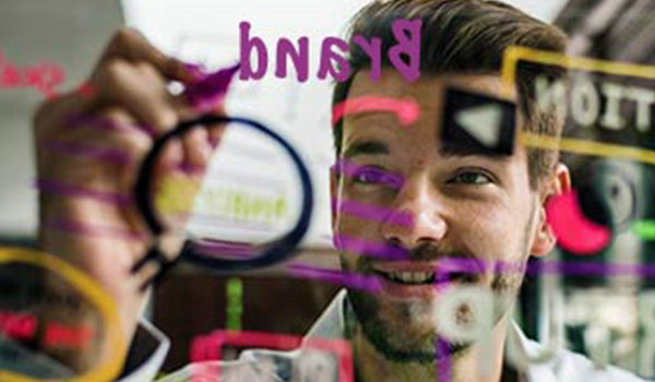 A man drawing on a whiteboard.