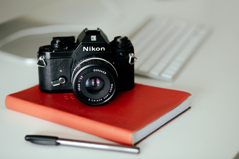 A Nikon camera on top of a journal.