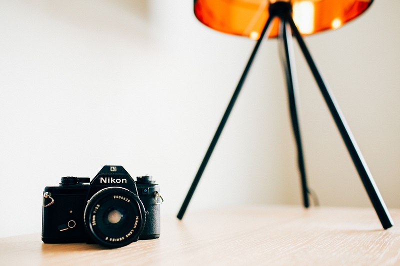 A Nikon camera in a white room.