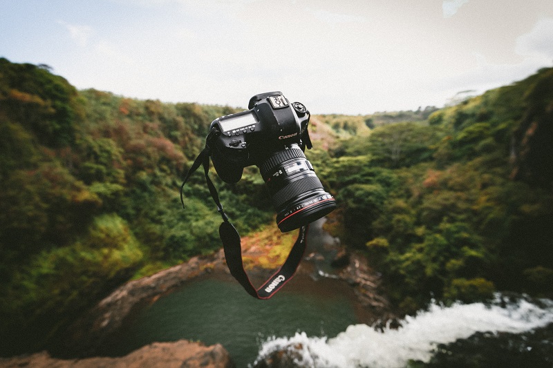 A floating Canon camera above a stream.