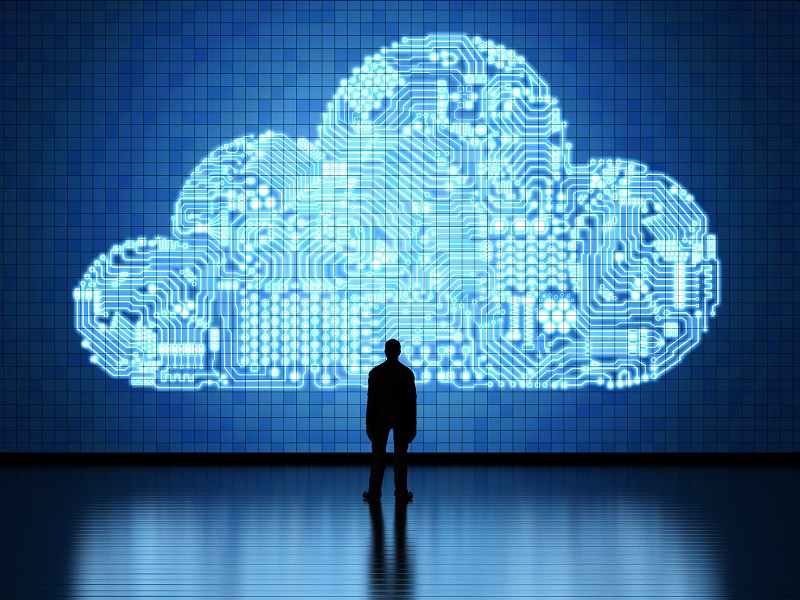 A person in front of a large digital cloud.