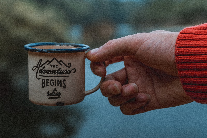 A cup of coffee with a slogan on it.