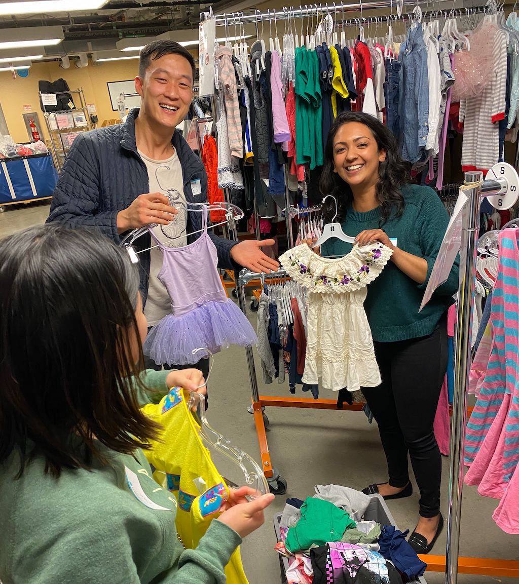 Photo of the Canto volunteers helping out at St. Anthony’s Free Clothing Program.