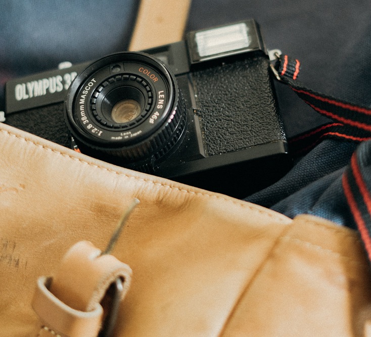 An Olympus camera in a tote bag.