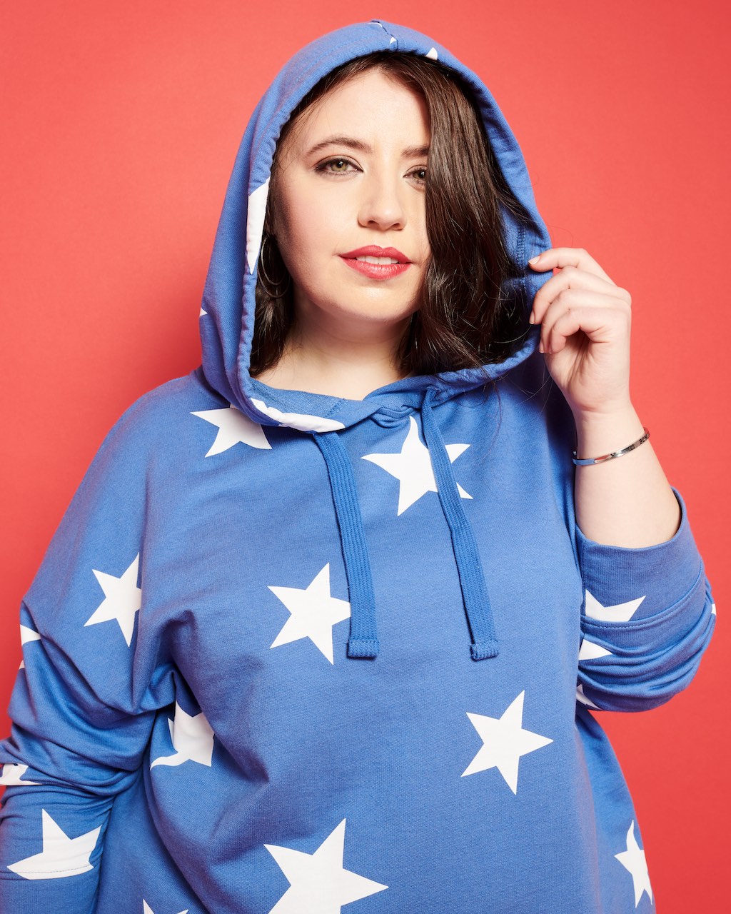 A woman wearing a hooded sweater.