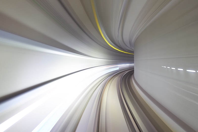 A picture of something speeding quickly through a tunnel.