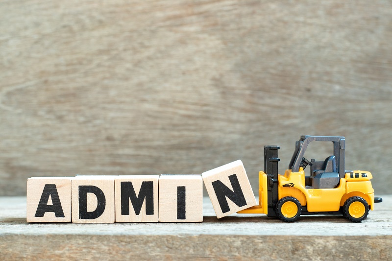 A toy tractor pulling the word 'admin' on blocks.