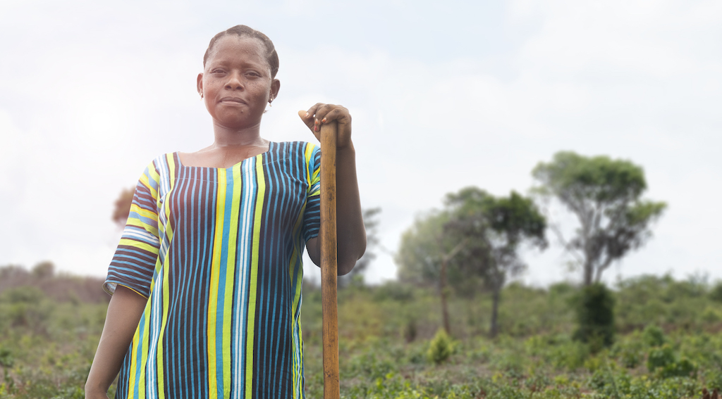 A female worker in a field, taking a break.