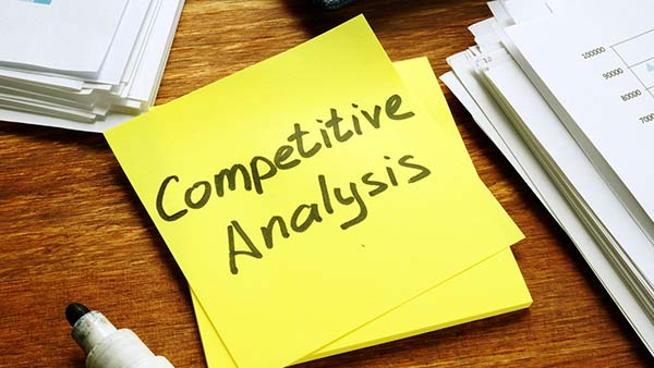 A sticky note that says 'competitive analysis'.