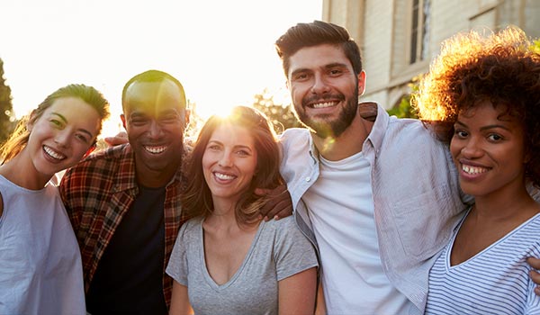 A group of young people smiling at a camera.