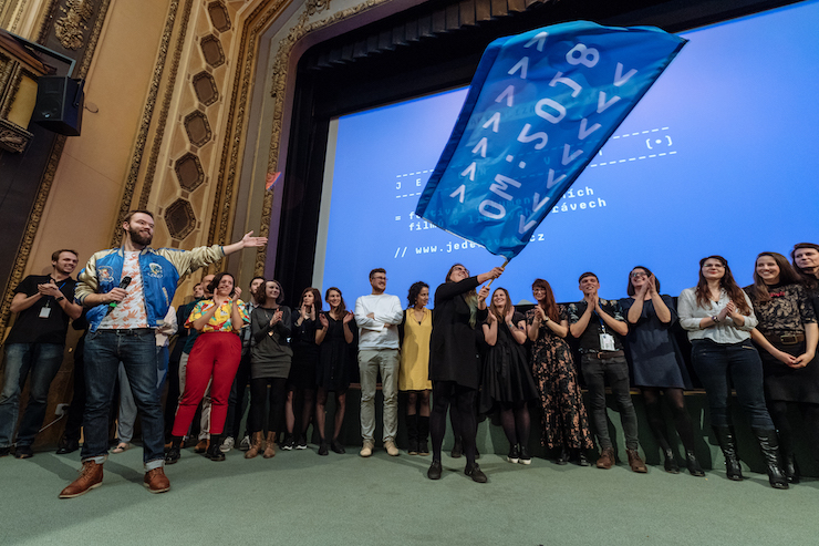 Happy people celebrating on a stage.