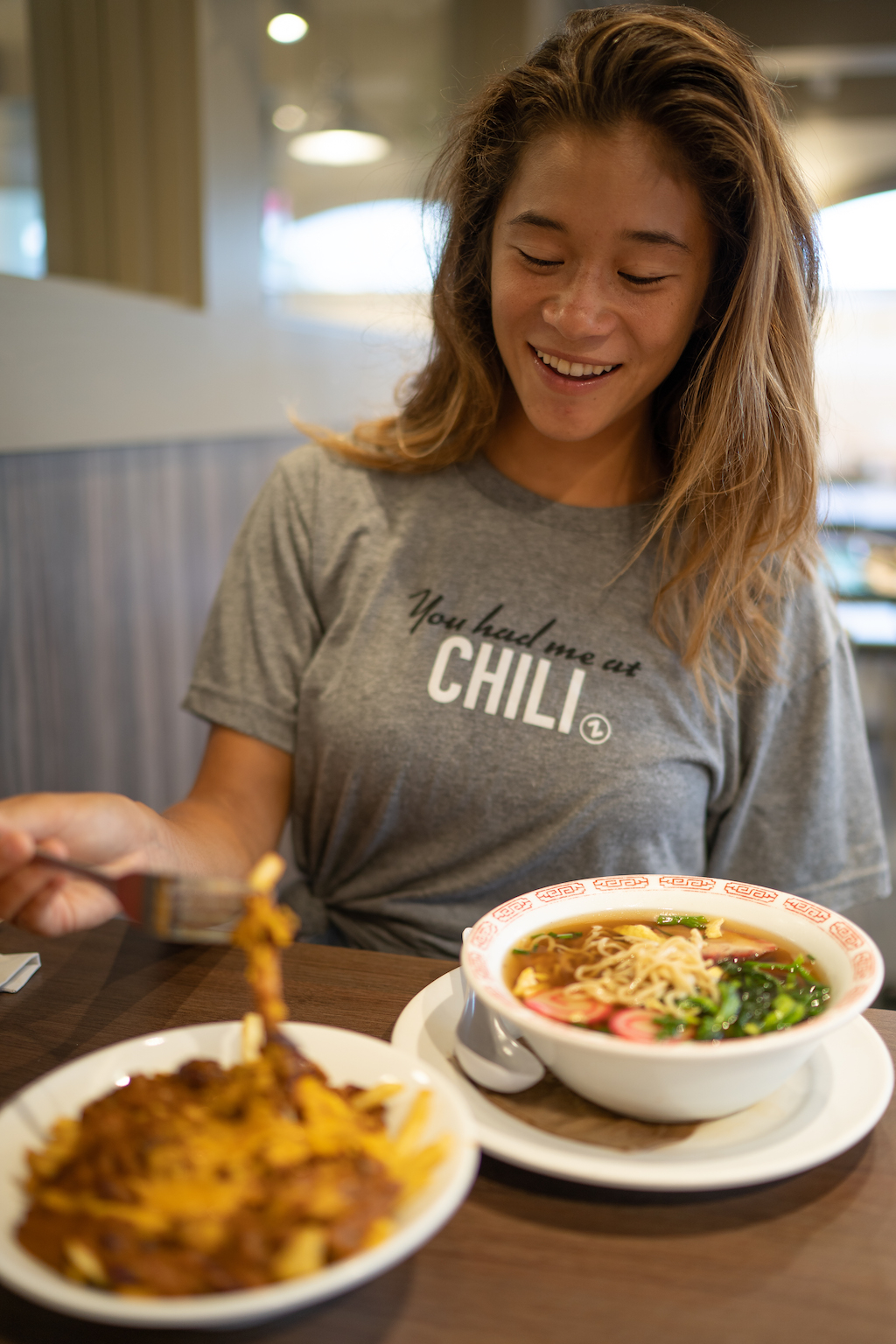 A woman enjoying a meal at Zippy's.