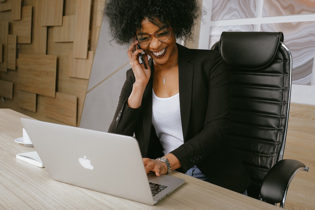 Woman sitting at a desk, working on a computer.