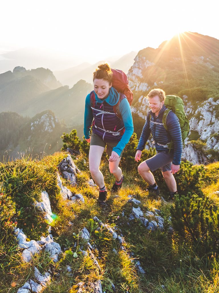 Two persons hiking a mountain pass.