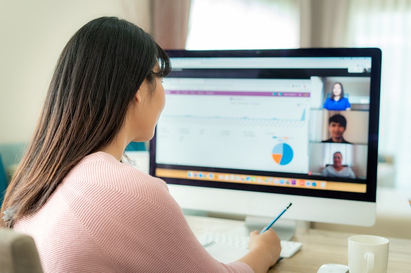 A young woman has a conference call online.