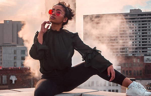 A young person modeling sunglasses.