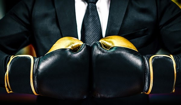 A businessperson wearing boxing gloves.