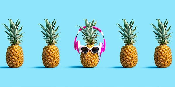 A pineapple wearing sunglasses and headphones.