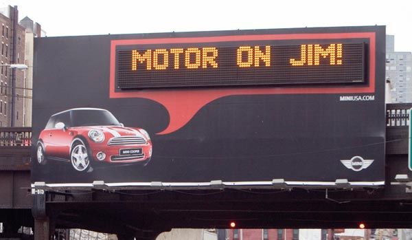 Personalized Mini Cooper billboard with a digital display that reads: Motor on Jim.