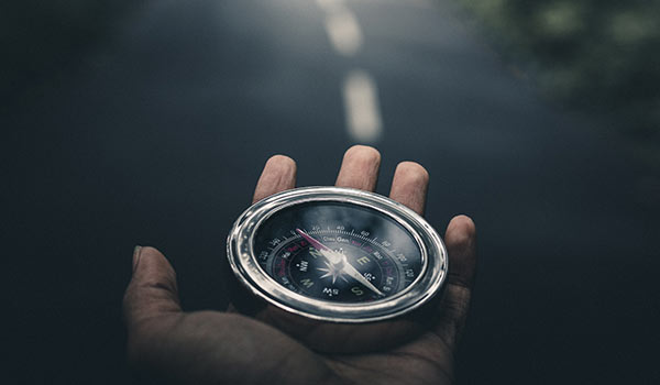 A person holding a compass.